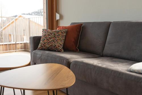 a living room with a couch and a table at AlmApp Nassfeld in Sonnenalpe Nassfeld