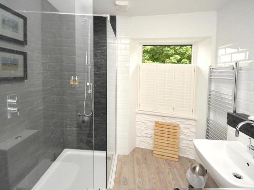 a bathroom with a tub and a sink and a shower at The Steam Packet Inn in Totnes
