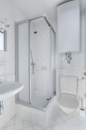 a bathroom with a shower and a toilet and a sink at Angela in Sonnenalpe Nassfeld