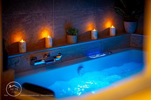 a bathroom with a tub with lights and candles at Chic & Spa l Ascenseur l Terrasse centre ville in Chambéry