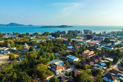an aerial view of a small town next to the ocean at Tongtong Garden Holiday Hotel普吉岛通通花园酒店 in Rawai Beach