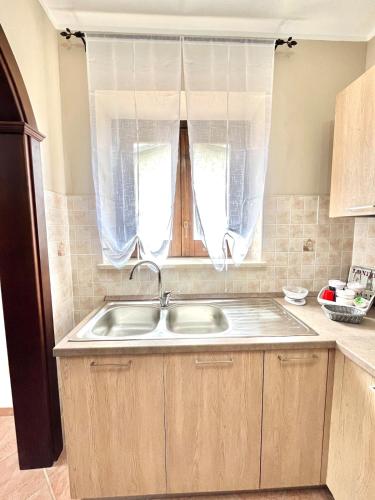 a kitchen with a sink and a window at Casa di Simone in Grisolia