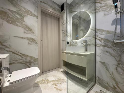 a bathroom with a toilet and a sink and a mirror at VITHΟS SUITE Luxury Living in Virós