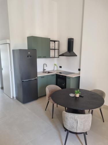 a kitchen with a table and a refrigerator at Villa Mila in Bol