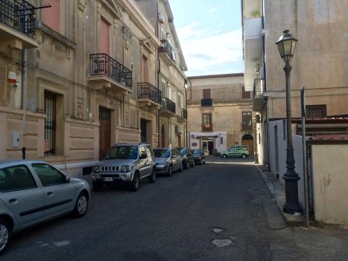 a row of cars parked on a city street at B&B Zia Iaia in Siderno Marina