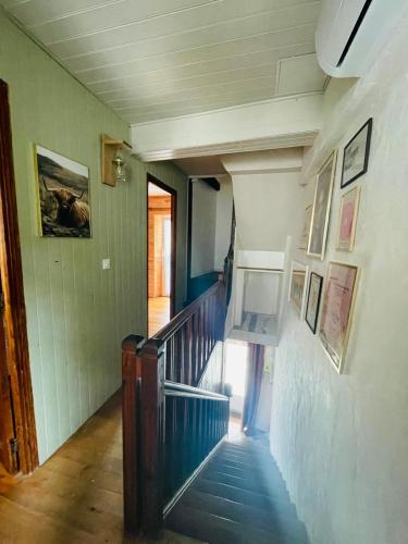 a hallway with a staircase in a house at Maisonnette de charme in Marignac