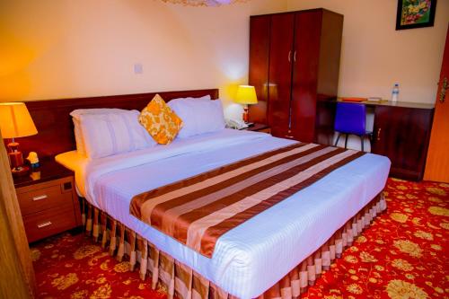 a bedroom with a large bed in a room at Ineza Hotel Musanze - Snow Hotel in Ruhengeri