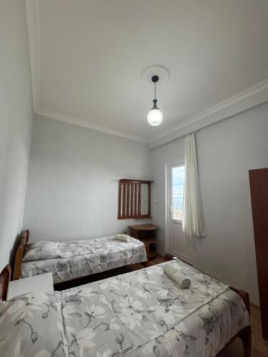 a bedroom with two beds and a window at Temo's guest house in Kvariati in Kvariati