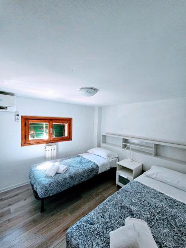 a hotel room with two beds and a window at Ca' Domame in Venice-Lido