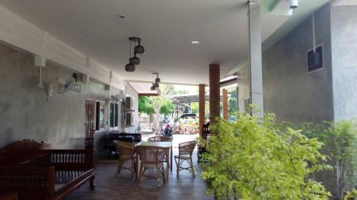 a dining room with a table and chairs at Pottery Street House in Sukhothai