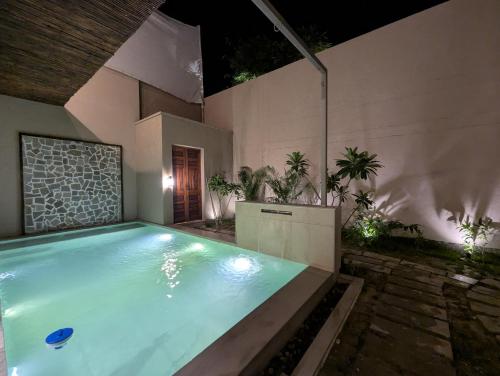 a large swimming pool in a building with at Cape House in Amritsar