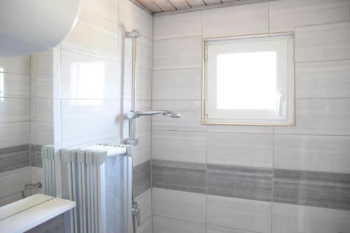 a bathroom with a shower and a window at Villa Luger 2 Dachgeschoss in Rogoznica