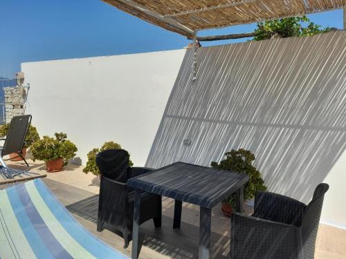 a black table and chairs on a patio at casa vacanze gioema baunei in Baunei