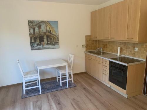 a kitchen with a table and a sink and a table and chairs at Kassel Nähe Universität und Klinikum krankenhaus in Kassel