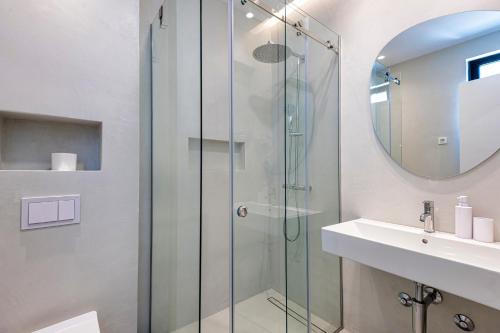 a bathroom with a glass shower and a sink at Lucciola Boutique Rooms in Budva