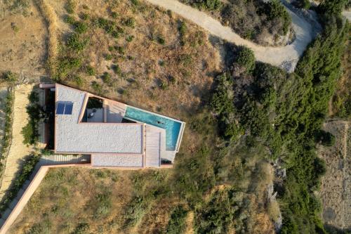 an overhead view of a house with a swimming pool at Casa Tarrha- Beachfront Villa with Heated Pool in Livadia