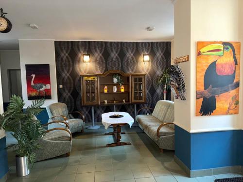 a living room with couches and a table at Rodar in Boguszów-Gorce