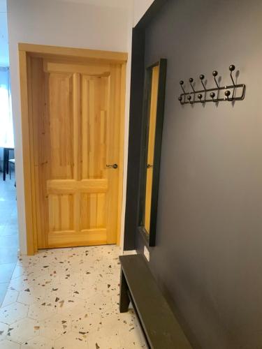 a room with a door and a wall with a tile floor at Linden apartment in Preiļi