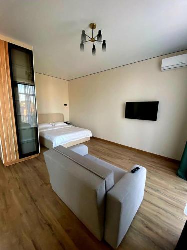 a living room with two beds and a couch at Современные апартаменты ЖК England Towers in Uralsk