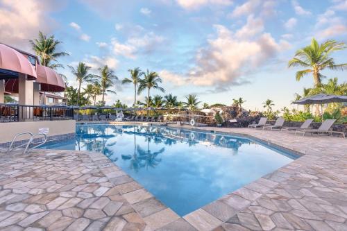 a swimming pool with palm trees and a resort at Wyndham Kona Coast Resort 2BR Apartment with Resort Access in Kailua-Kona