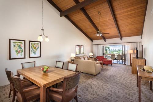 a dining room and living room with a wooden ceiling at Wyndham Kona Coast Resort 2BR Apartment with Resort Access in Kailua-Kona