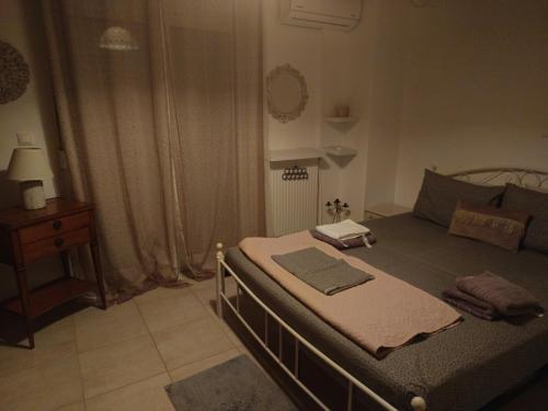 a bedroom with a bed and a dresser in it at Vasiliki's home in Kalyves Poligirou