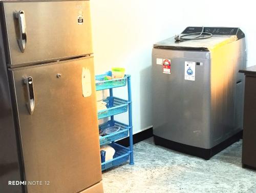 a kitchen with a refrigerator and a small freezer at sky blue Villa in Trincomalee
