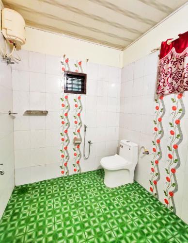 a bathroom with a toilet and a shower at Mist Nest Munnar in Munnar