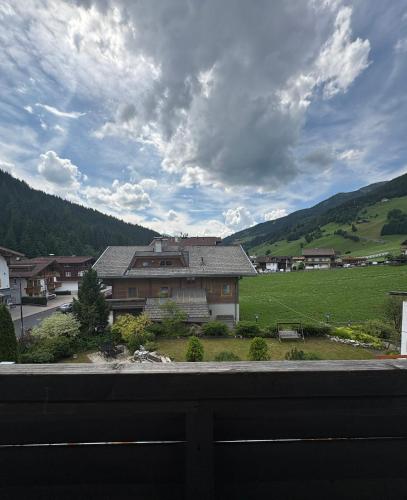 a view from a balcony of a house and a field at Gasthof Oberwirt in Gerlos