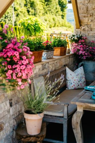 a bench with potted plants on a patio at Apartmany pod Pustevnami in Prostřední Bečva