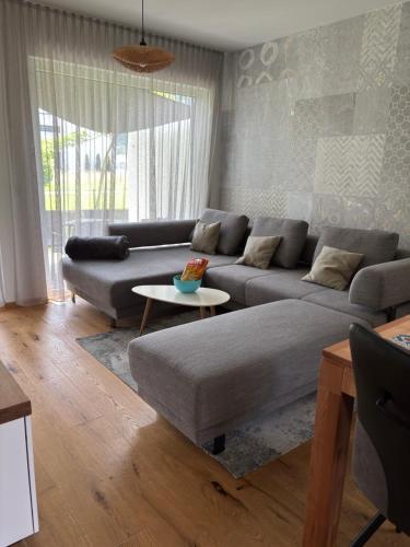 a living room with a couch and a table at Unicorn Apartment in Nüziders