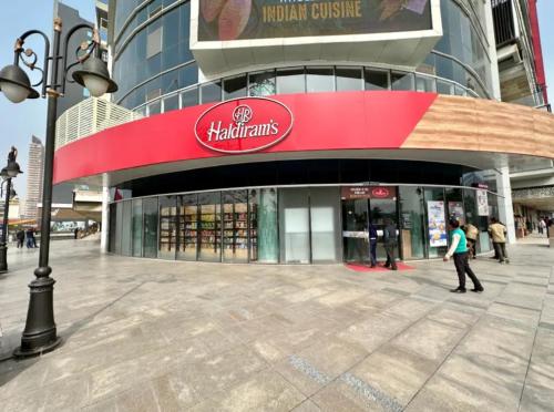 a shopping mall with a red sign on the front of it at CitySoulStay -1840 in Ghaziabad