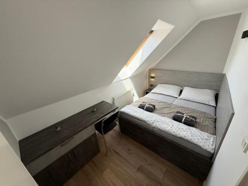 a bedroom with a bed and a wooden desk at Pálava Chalupa in Pavlov