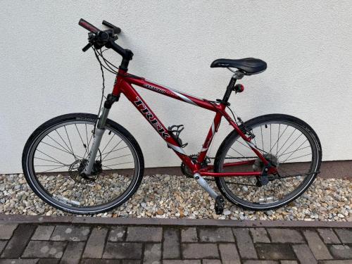 a red bike is parked next to a wall at Pálava Chalupa in Pavlov
