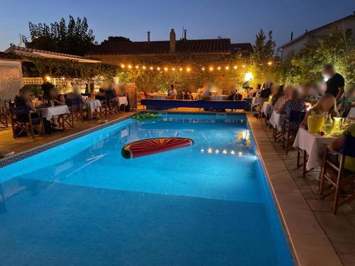 a swimming pool with a red boat in the middle at Le Galion Hotel et Restaurant Canet Plage - Logis in Canet-en-Roussillon