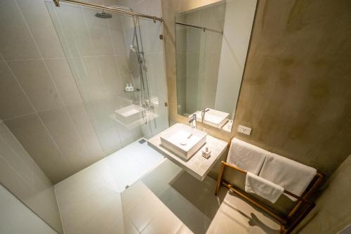 a bathroom with a sink and a shower at Mad Monkey Hoi An in Hoi An