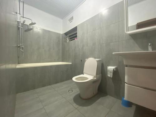 a bathroom with a toilet and a sink at BIZI HOMES in Kigali