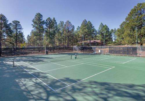 a tennis court with two tennis rackets on it at Wyndham Flagstaff Resort 2BR Apartment with Resort Access in Flagstaff
