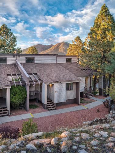 a house with a mountain in the background at Wyndham Flagstaff Resort 2BR Apartment with Resort Access in Flagstaff