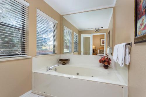 a bathroom with a tub and a large mirror at Wyndham Flagstaff Resort 2BR Apartment with Resort Access in Flagstaff