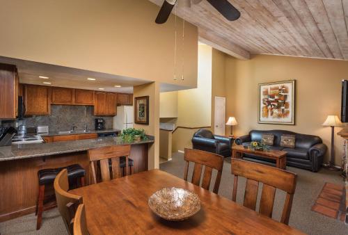a kitchen and living room with a table and a couch at Wyndham Flagstaff Resort 2BR Apartment with Resort Access in Flagstaff