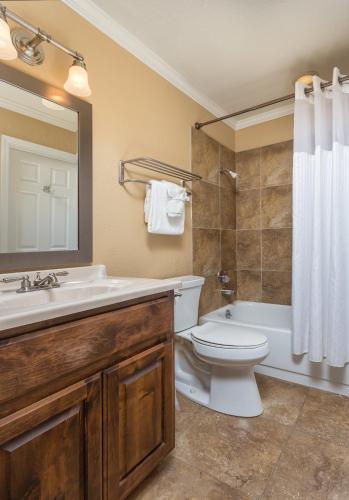a bathroom with a sink and a toilet and a tub at Wyndham Flagstaff Resort 2BR Apartment with Resort Access in Flagstaff