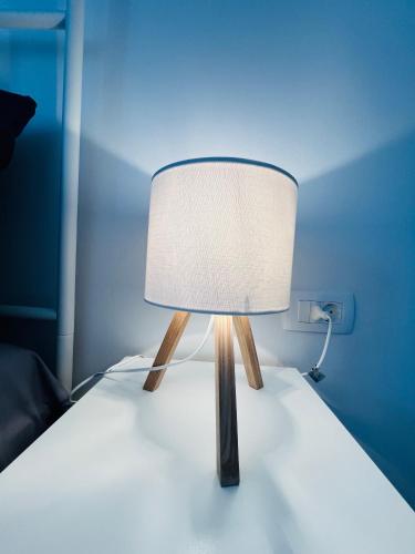a lamp sitting on top of a bed at Apartma DUDI 