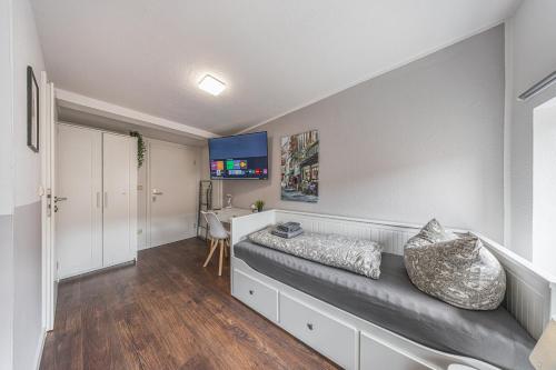 a living room with a couch and a desk at LS 3-Apartments Hauptbahnhof Halle in Halle an der Saale