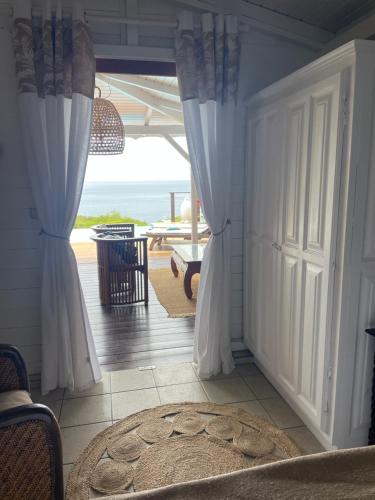 a room with a door with a view of the ocean at Villa Pelican Lodge in Deshaies