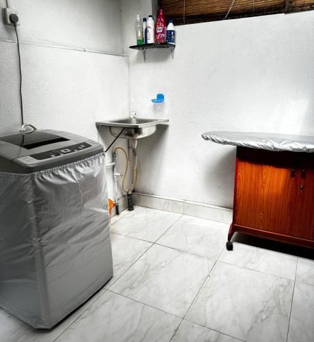 a kitchen with a sink and a counter and a counter at Frangipani House in Oruwala