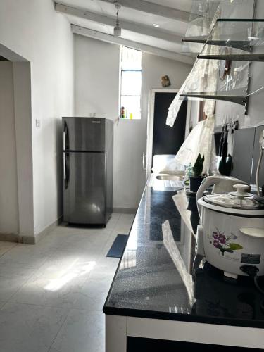 a kitchen with a counter top with a refrigerator at Frangipani House in Oruwala