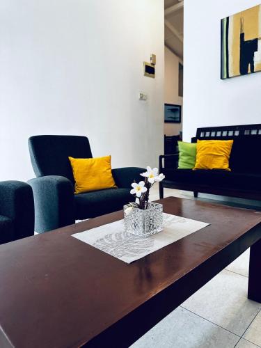 a living room with two couches and a coffee table at Frangipani House in Oruwala