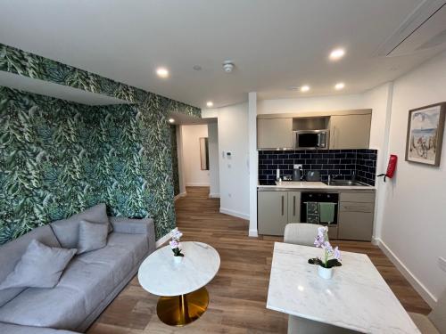 a living room with a couch and two tables at Bournemouth Lookout in Bournemouth