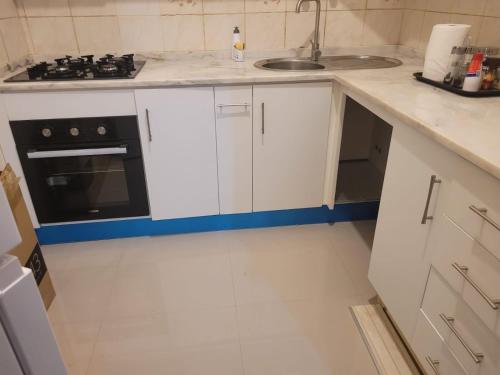 a white kitchen with a sink and a stove at Casa da Alegria in São Tiago